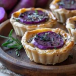 Purple sweet potato tarts on a rustic plate.